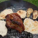 Lamb shoulder and flatbreads cooked on a campfire