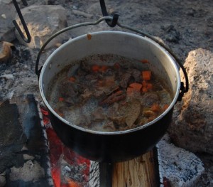 Venison stew cooked over the campfire