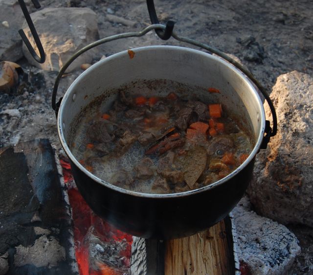 Venison stew cooked over the campfire