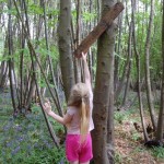 Adjusting a sign in the woods at Welsummer campsite