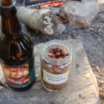 Harissa almonds with a bottle of beer beside the campfire