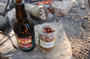 Harissa almonds with a bottle of beer beside the campfire