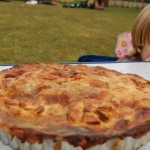 Festival pie on a table with a boy smiling