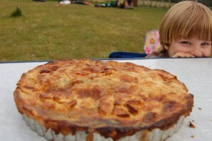 Festival pie on a table with a boy smiling