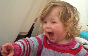 A toddler shouting No